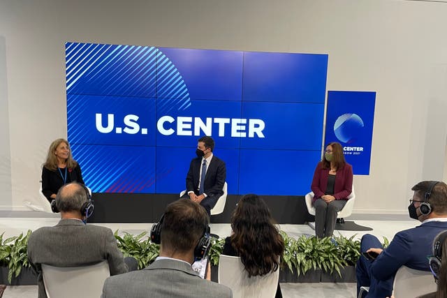 <p>US Transport Secretary Pete Buttigieg (center) and climate scientist Dr Katharine Hayhoe discuss decarbonizing transportation at Cop26 in Glasgow on Wednesday</p>