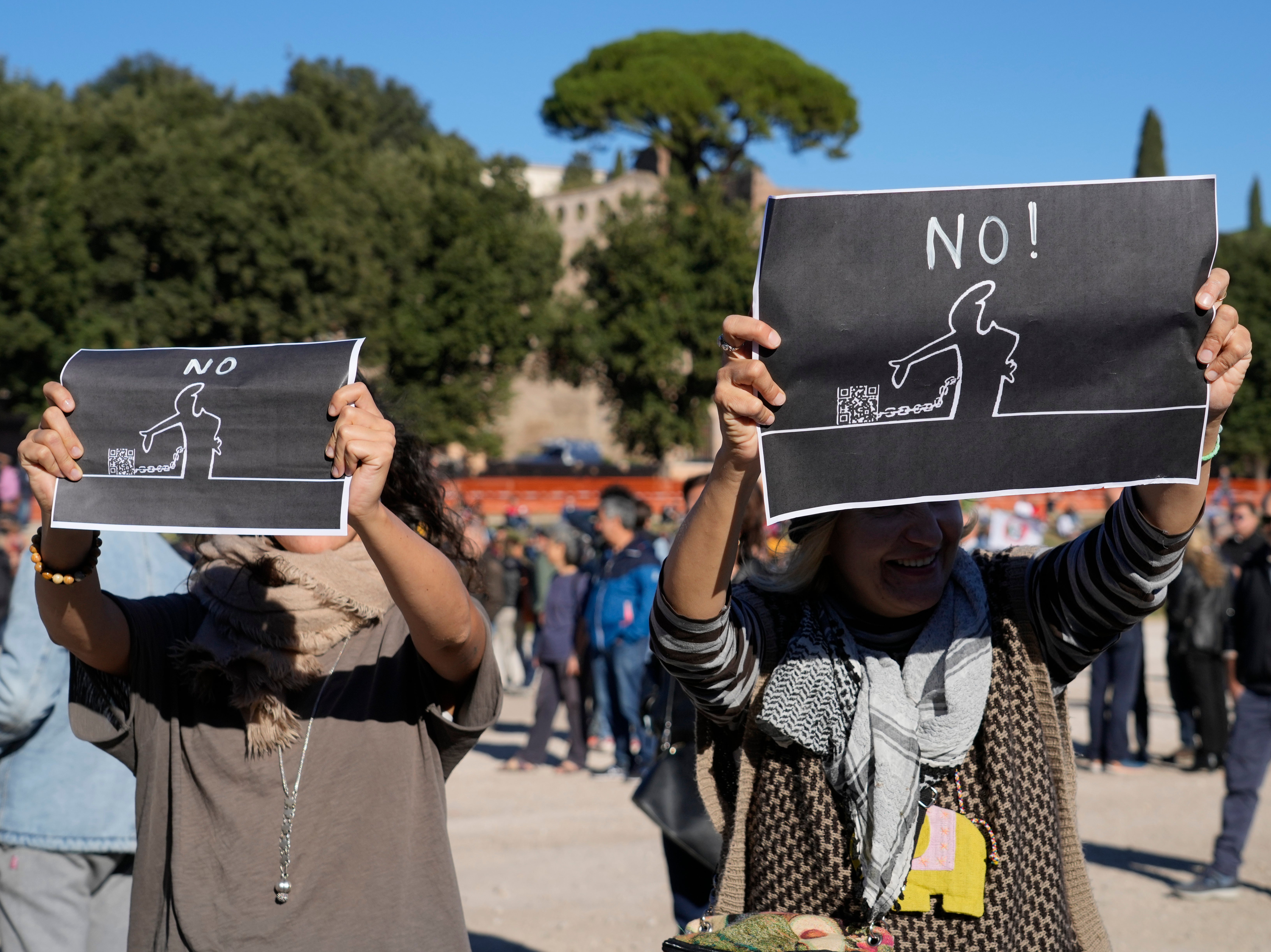Demonstrators show placards against the so-called ‘green ‘pass’, an electronic proof of vaccination, in Rome last month