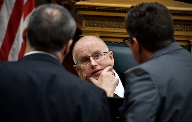 <p>Judge Bruce Schroeder (C) talks with Kyle Rittenhouse’s lead attorney Mark Richards (L) and assistant district attorney Thomas Binger at the end of the day's proceedings at the Kenosha County Courthouse  on 8 November 2021 in Kenosha, Wisconsin </p>