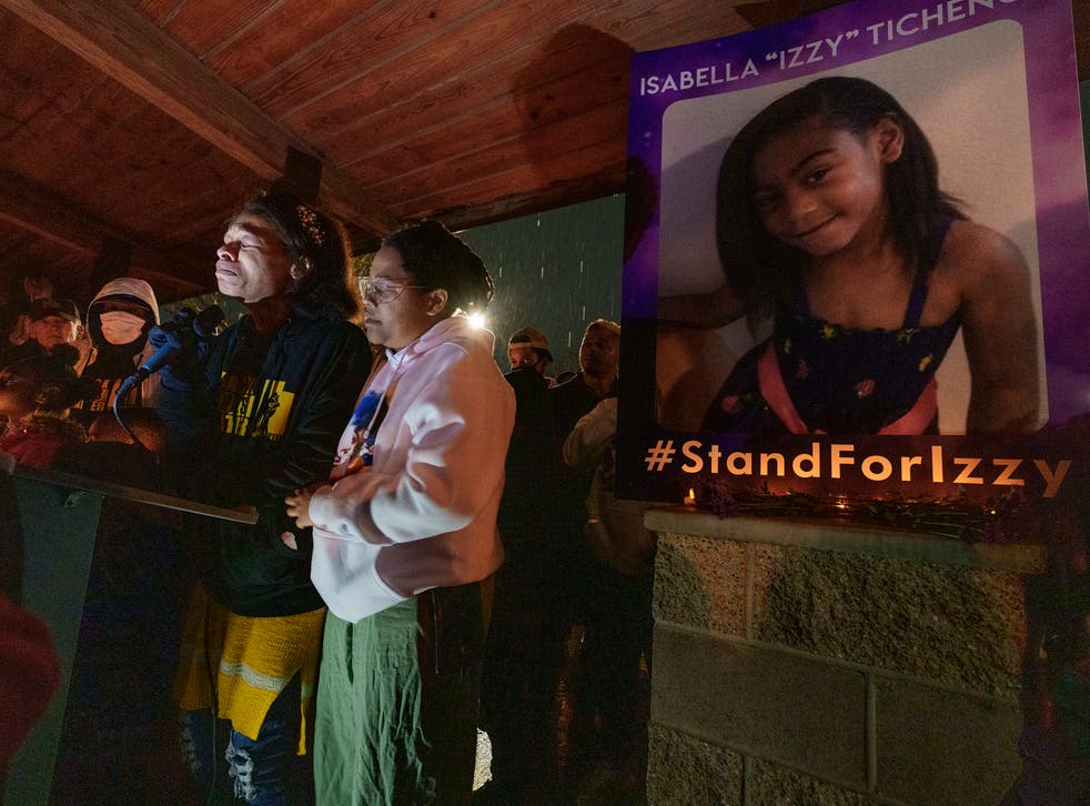<p>Brittany Tichenor- Cox joined by her sister Jasmine Rhodes, right, speaks about her daughter Izzy Tichenor, as hundreds joined the Tichenor family in mourning the death of 10-year-old Isabella "Izzy" Tichenor during a vigil at Foxboro Hollow Park in North Salt Lake, Utah,  on Tuesday, 9 November 2021</p>