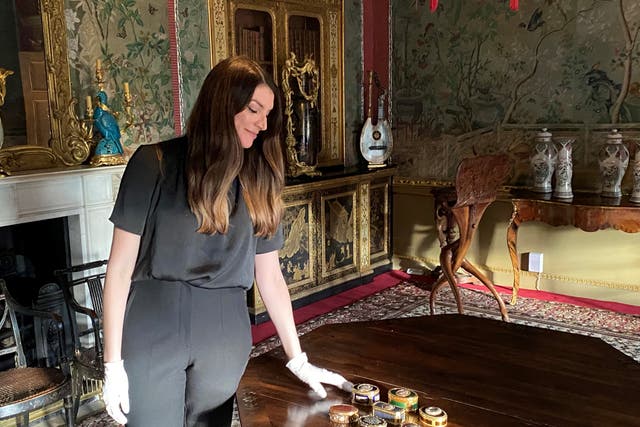 <p>Lauren Farrington with the collection of snuff boxes</p>