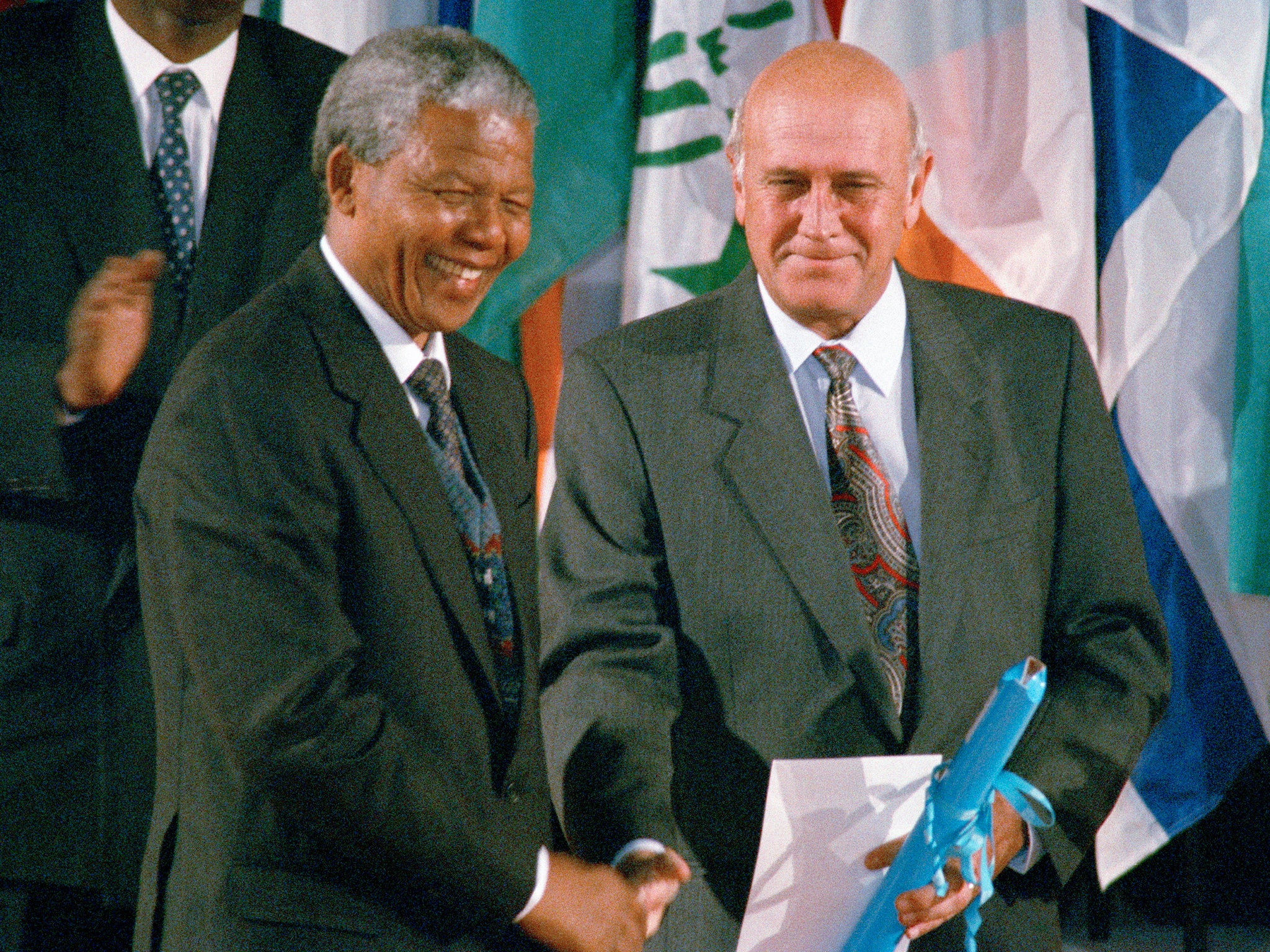 FW De Klerk, right, shakes hands with Nelson Mandela, after they received the Peace Prize in Paris in 1992