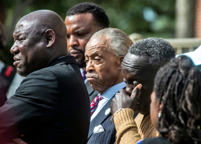 <p>Ahmaud Arbery's father, Marcus Arbery, right, wipes his eyes alongside the Rev. Al Sharpton center, as Lee Merritt, left, one the family's lawyers speaks outside the Glynn County courthouse, Wednesday, Nov. 10, 2021</p>
