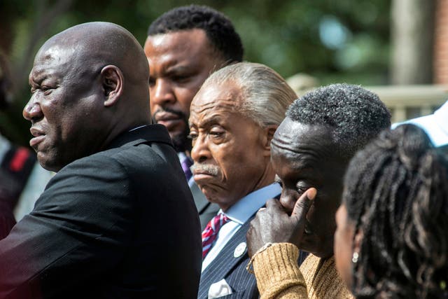 <p>Ahmaud Arbery's father, Marcus Arbery, right, wipes his eyes alongside the Rev. Al Sharpton center, as Lee Merritt, left, one the family's lawyers speaks outside the Glynn County courthouse, Wednesday, Nov. 10, 2021</p>