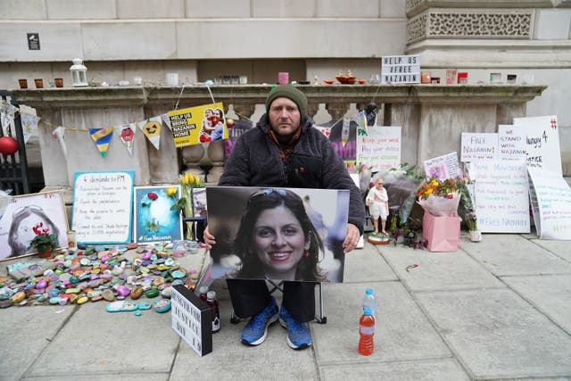 <p>Richard Ratcliffe holds a picture of his wife Nazanin Zaghari-Ratcliffe on the 19th day of his hunger strike</p>
