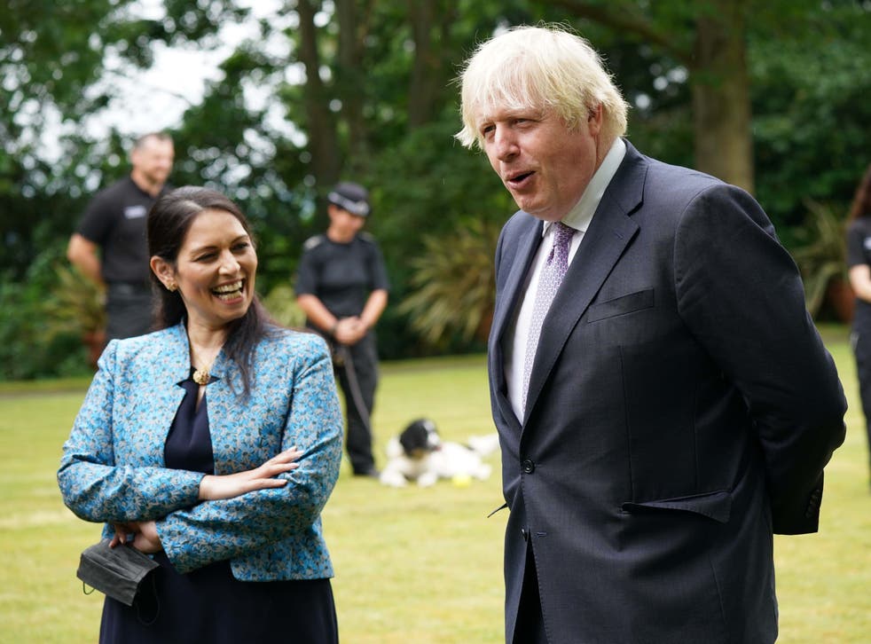 <p>Home secretary Priti Patel and Boris Johnson on visit to Surrey Police headquarters in Guildford</p>