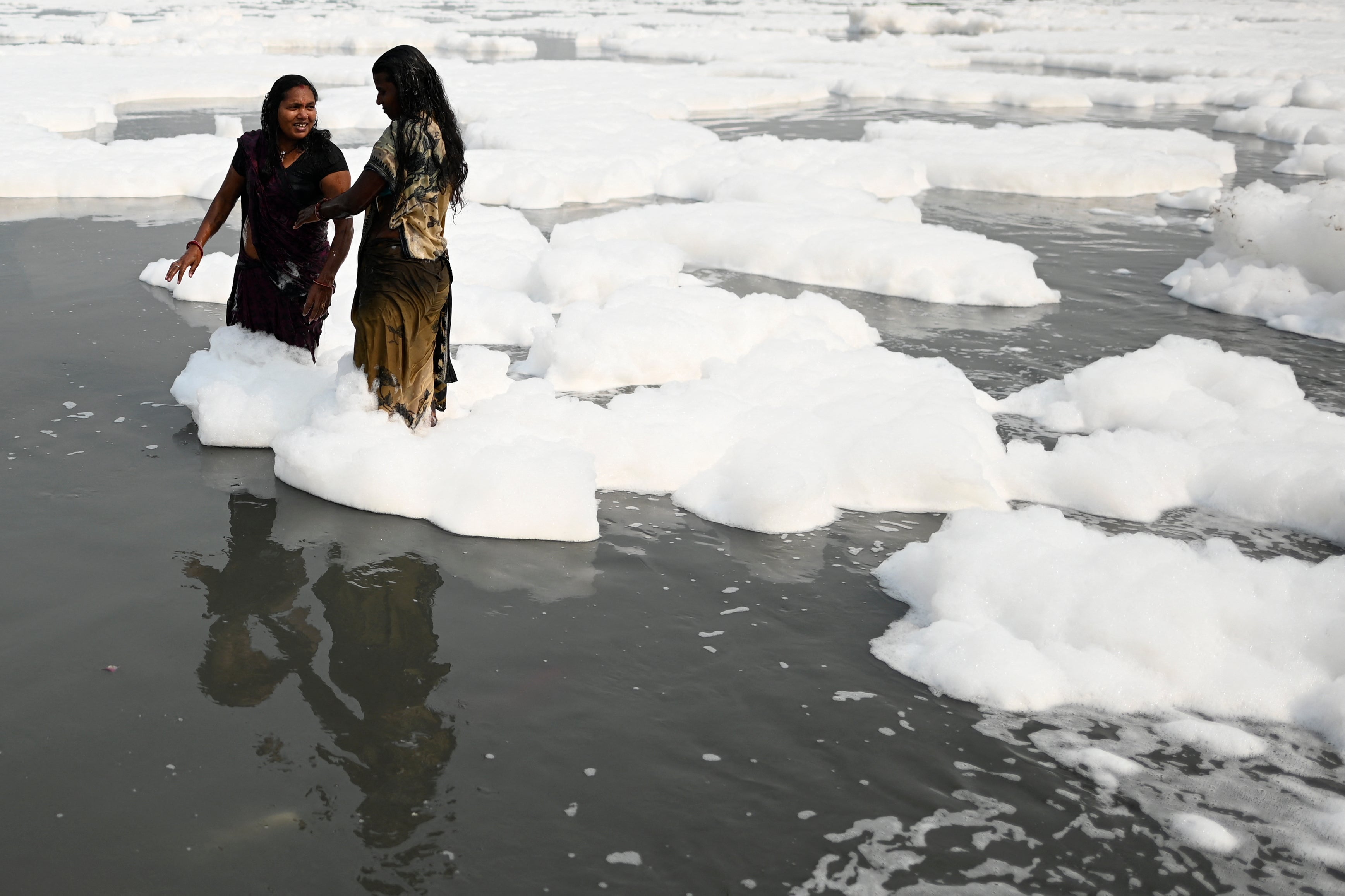 Worshippers stand in the Yamuna, undeterred by its pollution