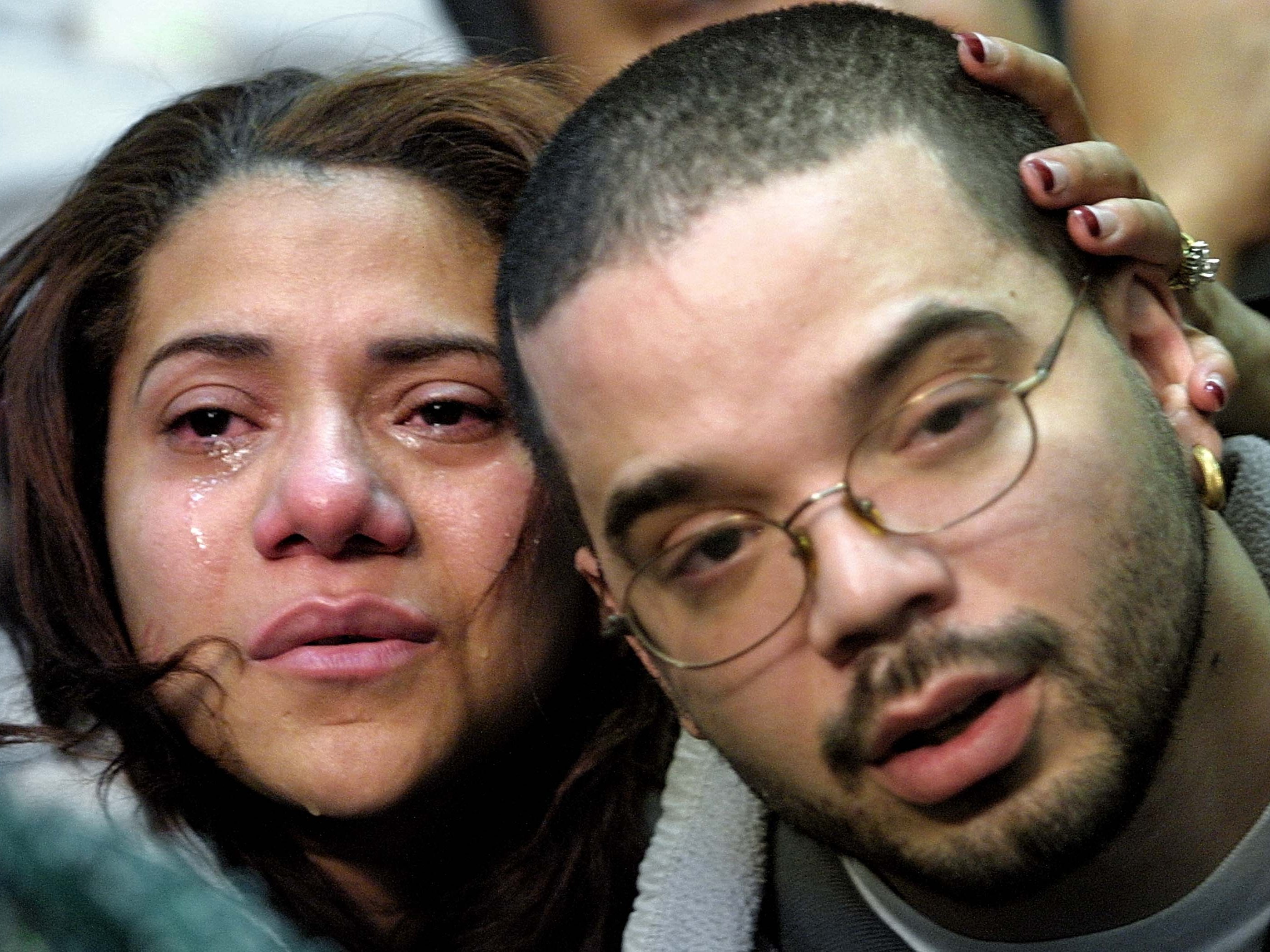 Maxima Nunez and Carlos Morales grieve at a service for family members of the victims of the American Airlines Flight 587 crash on 12 November 2001 in New York City. Morales lost both his parents in the crash