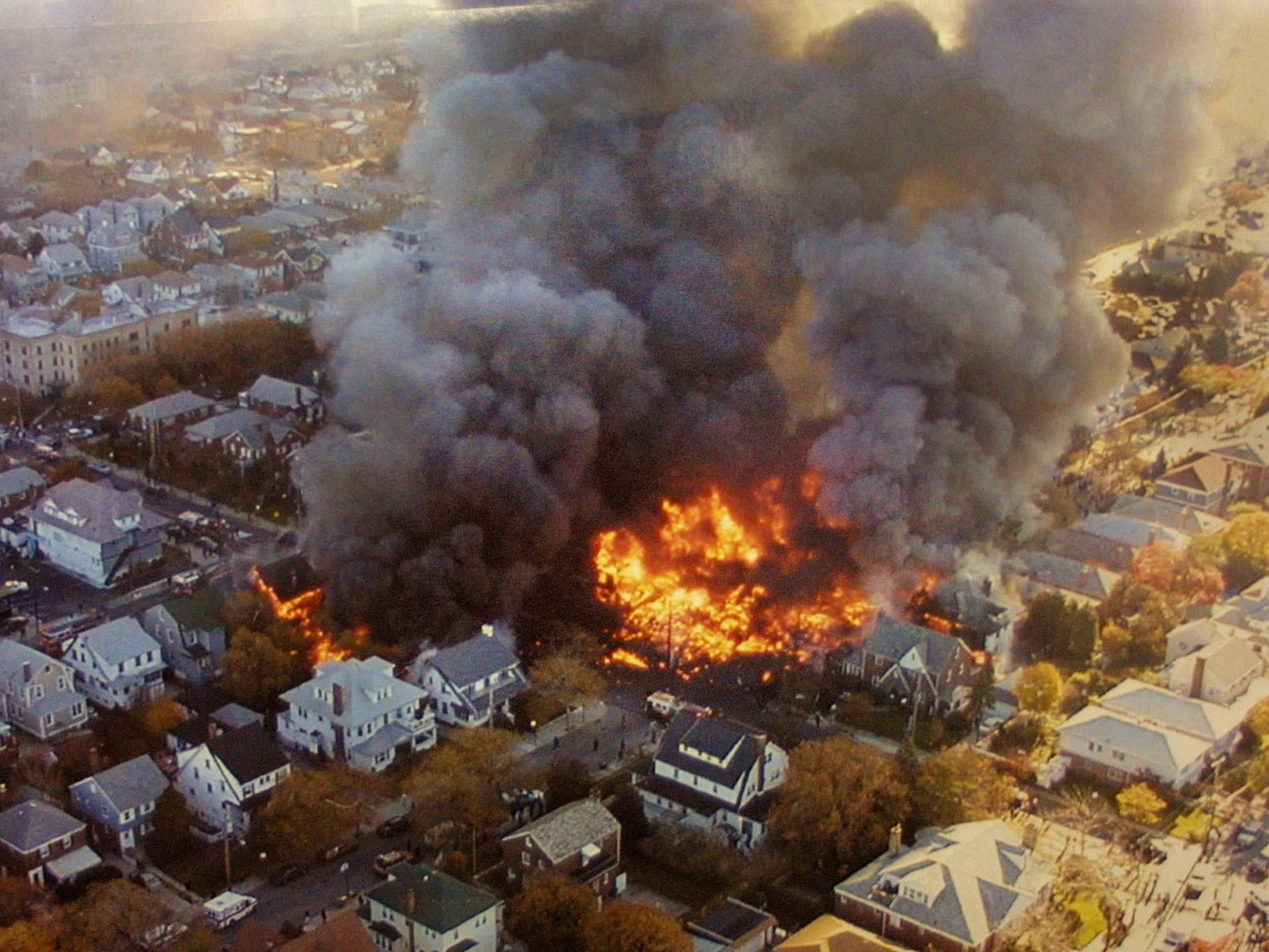 The wreckage of American Airlines Flight 587 burns in the Rockaway neighborhood of Queens, New York City, on 12 November 2001