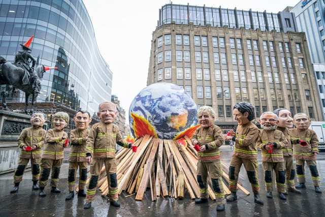<p>Campaigners wearing ‘big heads’ of world leaders, including Boris Johnson, Joe Biden, Justin Trudeau and Narendra Modi, gather for Oxfam’s ‘Ineffective Fire-Fighting World Leaders’ protest performance during the official final day of the Cop26 summit in Glasgow</p>