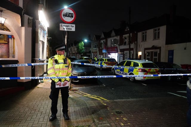 <p>Police at the scene in Albany Parade in Brentford where a man has been killed</p>