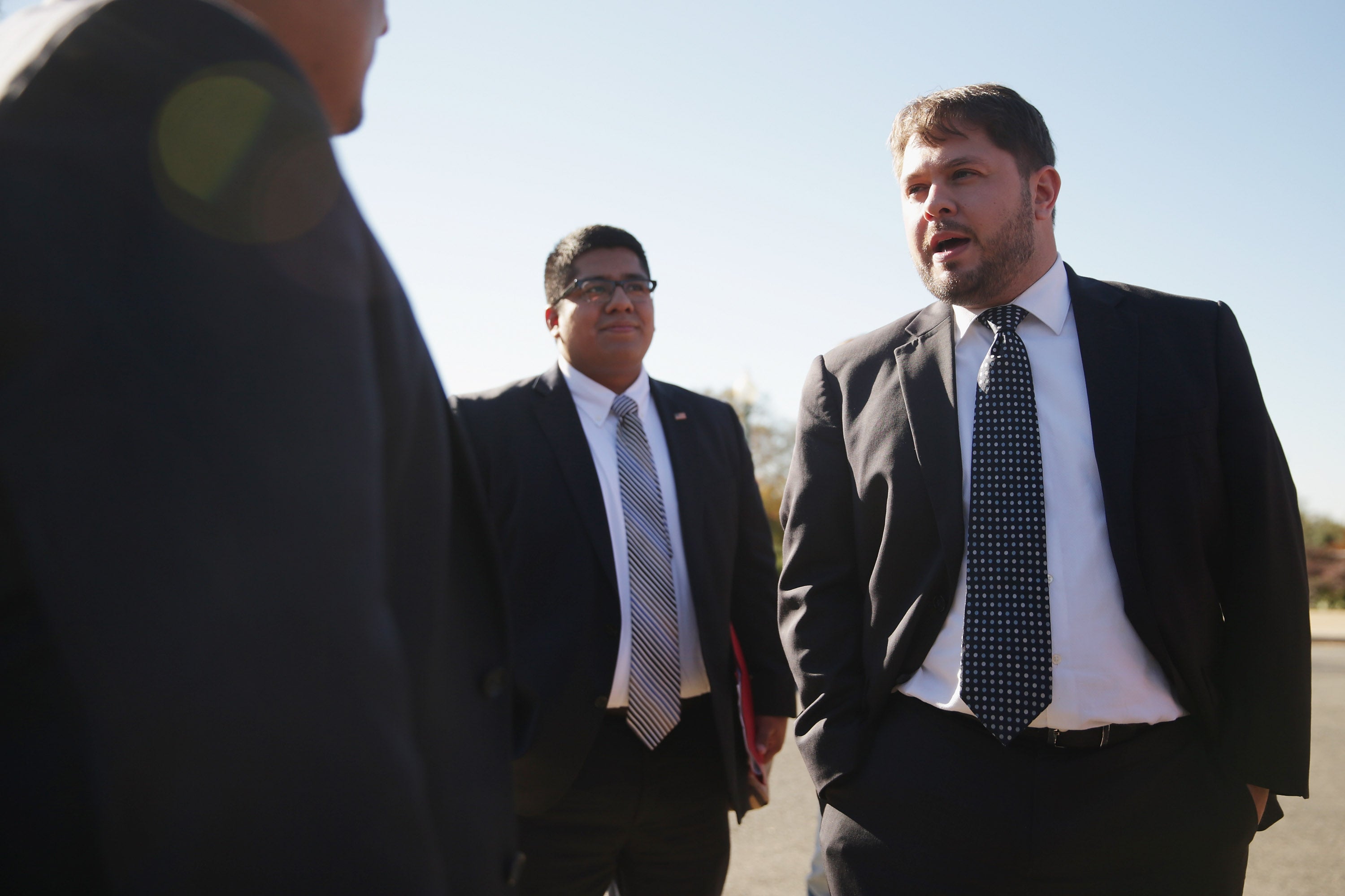 Representative-elect Ruben Gallego (D-AZ) (R) talks with fellow military veterans before a news conference to call on Congress and President Barack Obama to move forward with immigration reform at the U.S. Capitol November 12, 2014 in Washington, DC