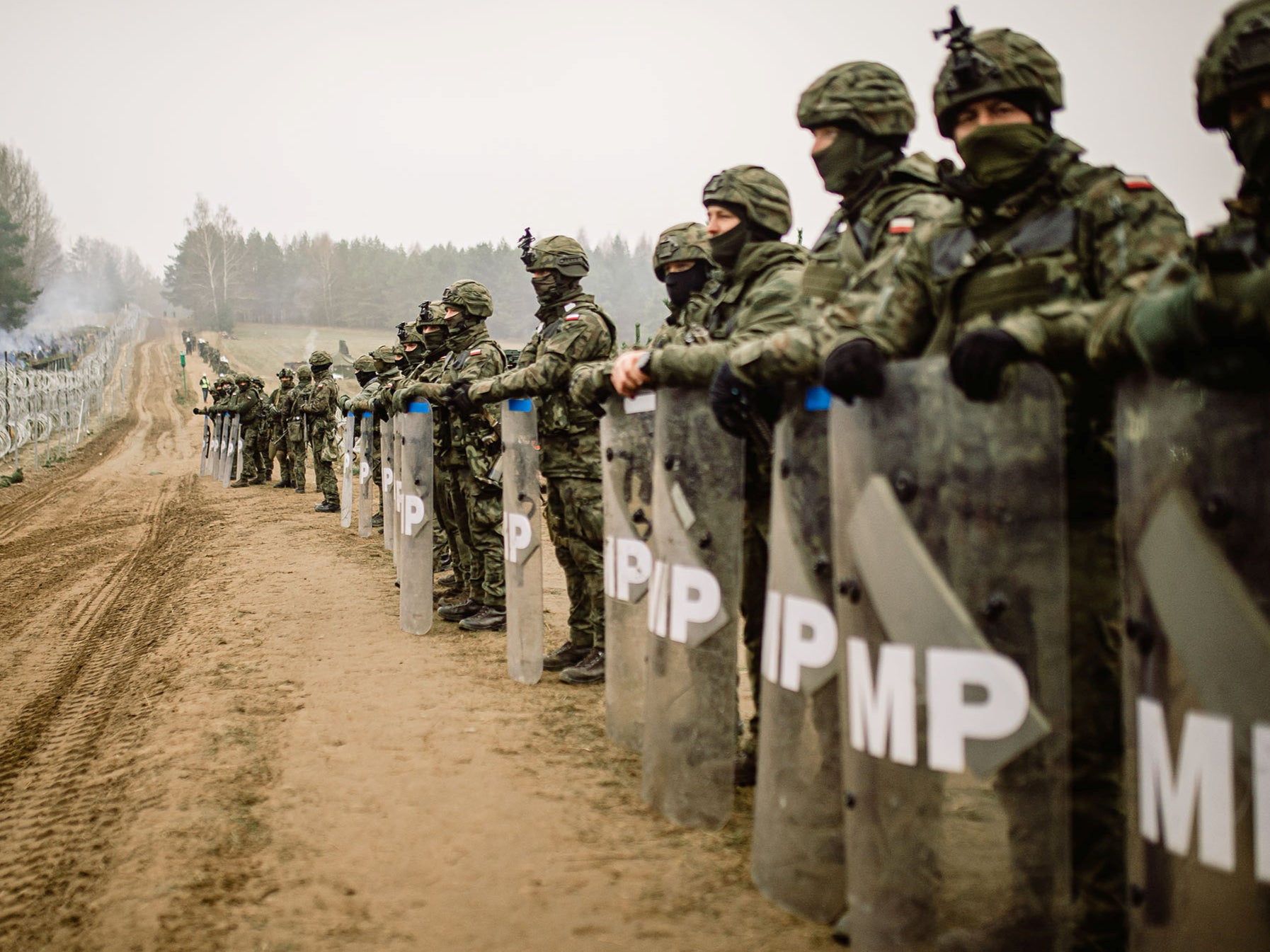 Polish military police guard their country’s side of the border with Belarus