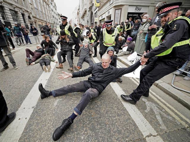 <p>Police remove Extinction Rebellion protesters during the Lord Mayor's Show parade  in the City of London</p>