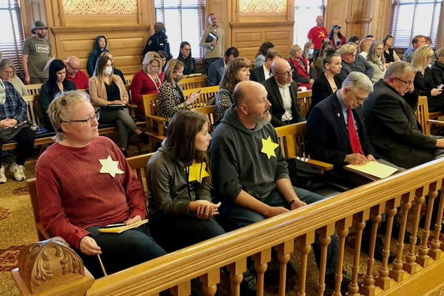 <p>Former Kansas City mayoral candidate Daran Duffy and his wife and daughter wearing yellow stars at the hearing on Friday</p>