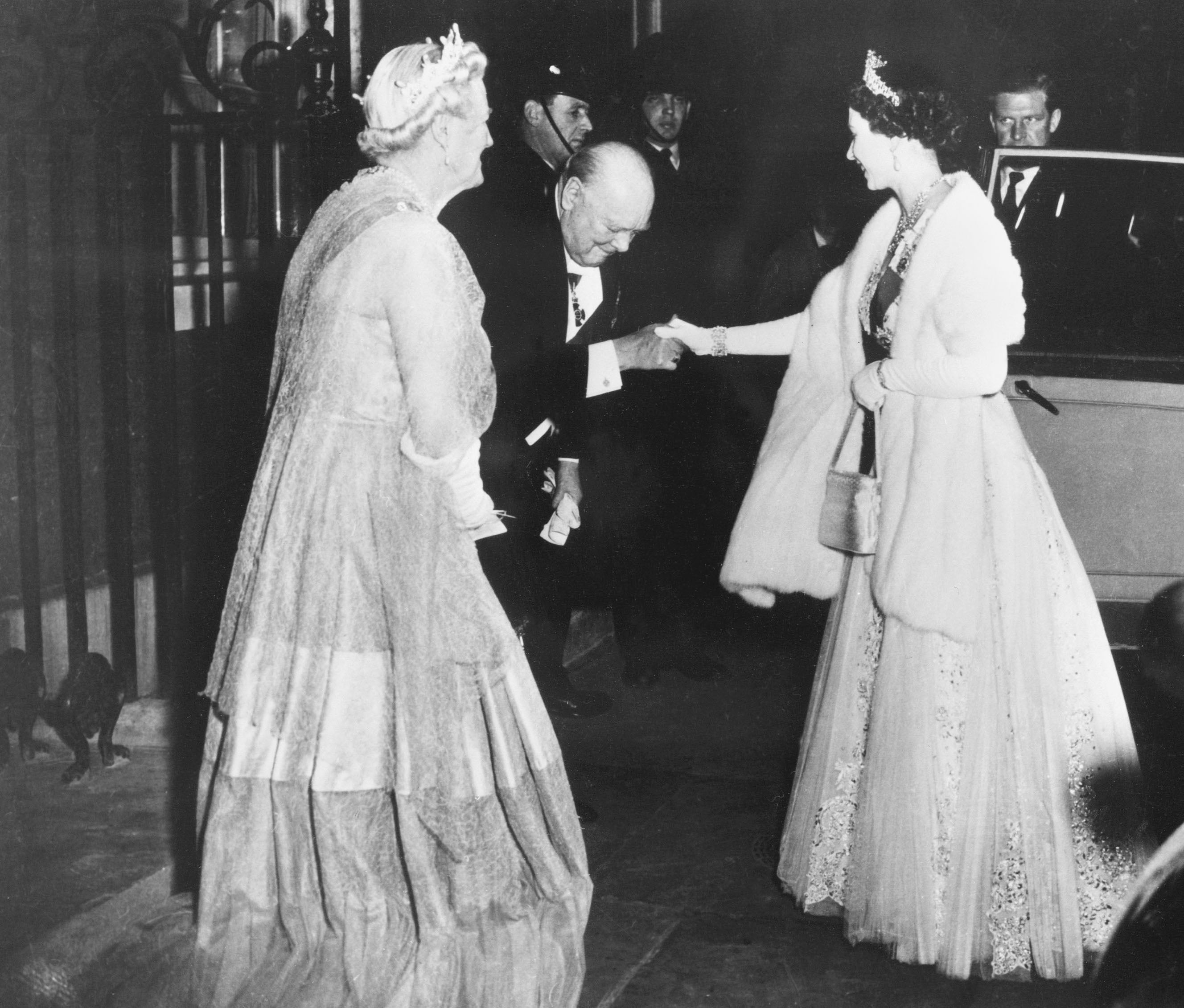 Prime minister Winston Churchill kisses Queen Elizabeth II’s hand as she leaves No 10 after a dinner given by the PM on 4 April 1955. Churchill was the first PM the Queen worked with during her reign