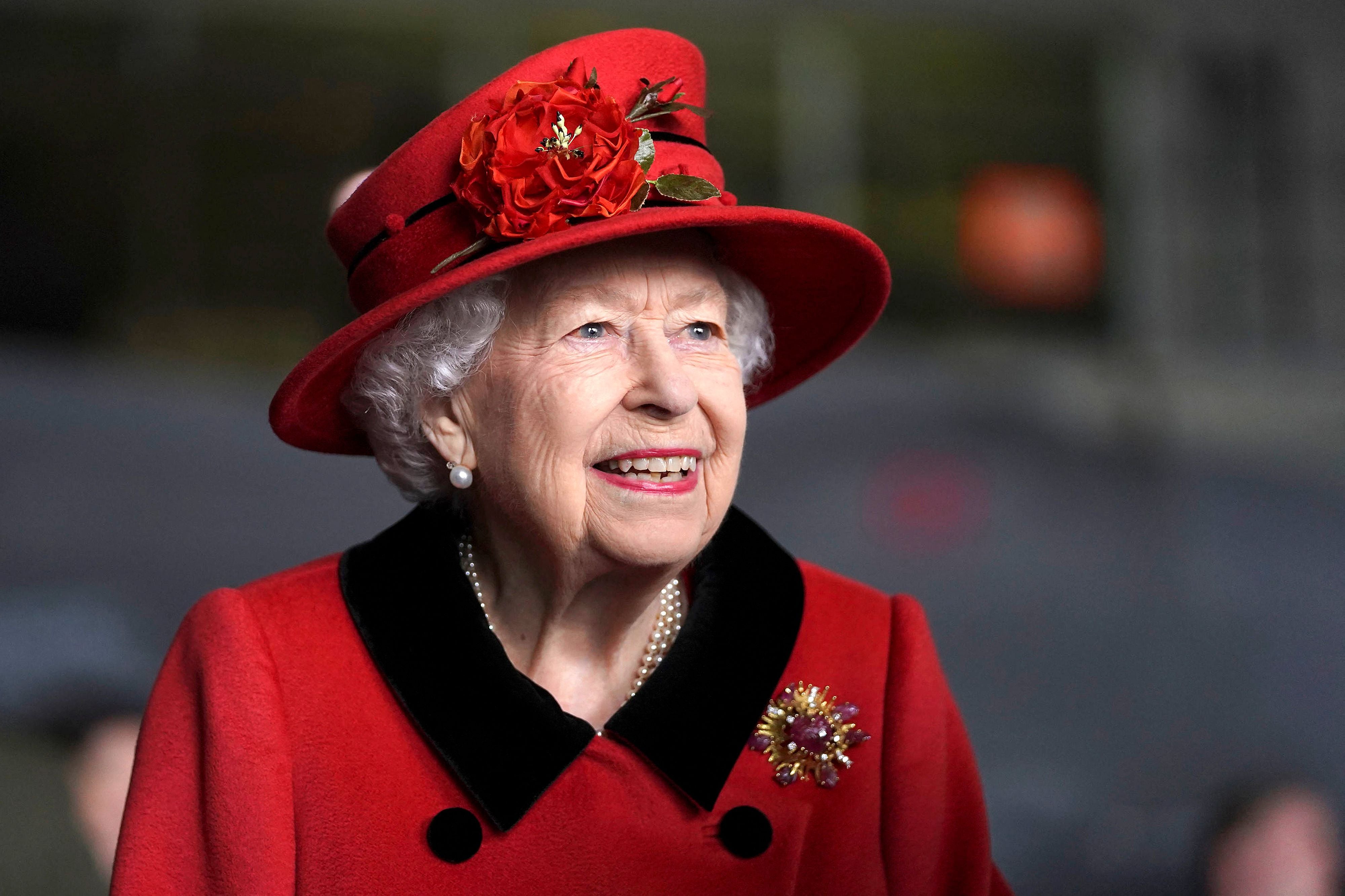 Queen Elizabeth II reacts during her visit to the aircraft carrier HMS Queen Elizabeth in Portsmouth on 22 May, 2021, ahead of its maiden operational deployment to the Philippine Sea