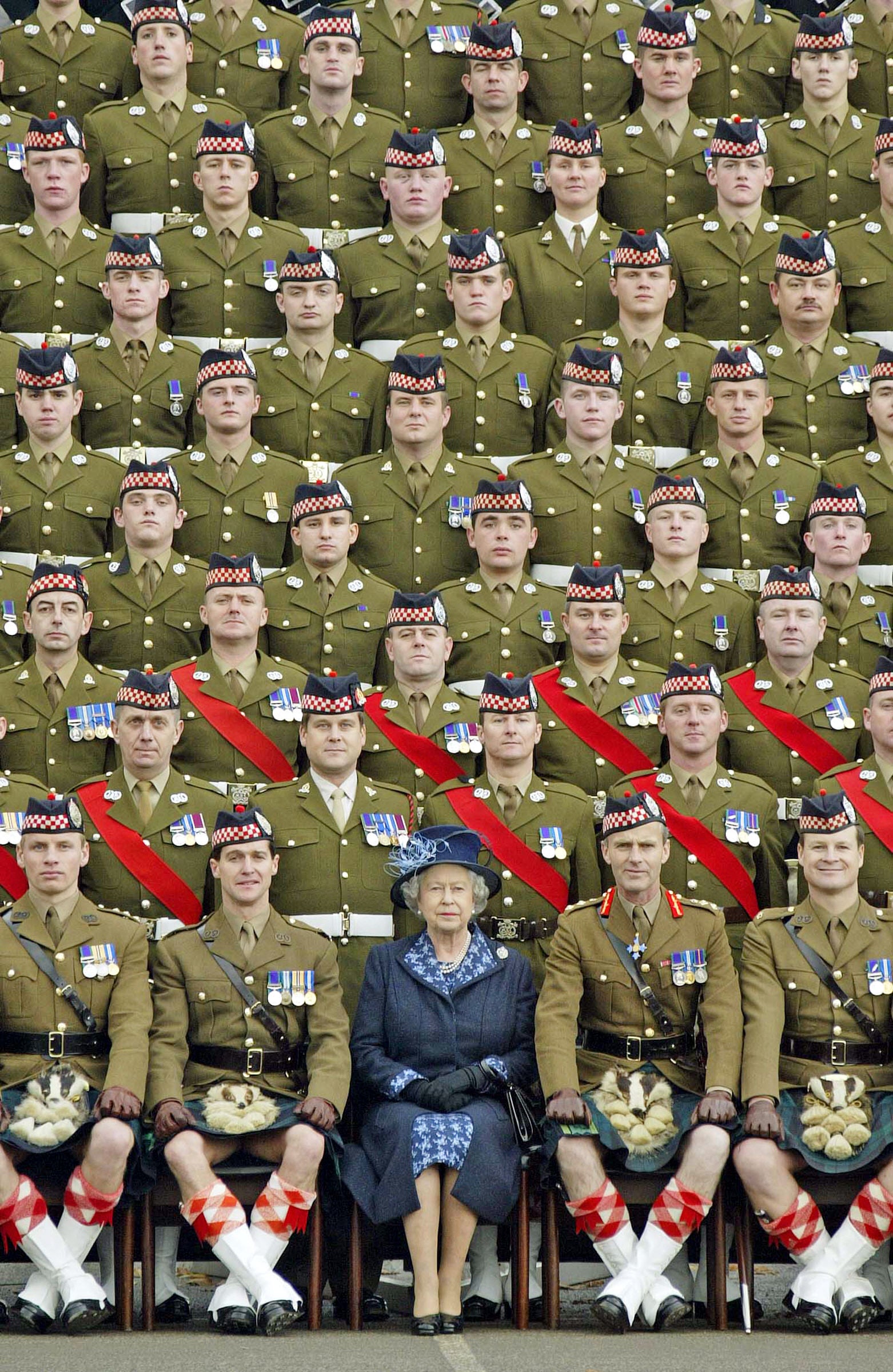Queen Elizabeth II poses for a picture with members of the 1st Battalion of the Argyll and Sutherland Highlanders at Howe Barracks in Canterbury, 2004