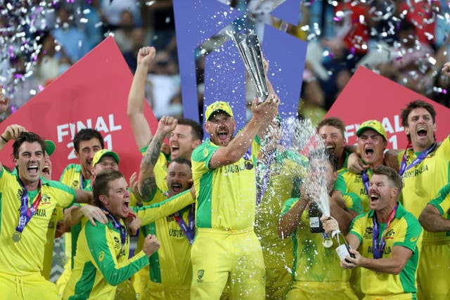 Australia captain Aaron Finch raises the trophy with his victorious team-mates (Kamran Jebreili/AP).