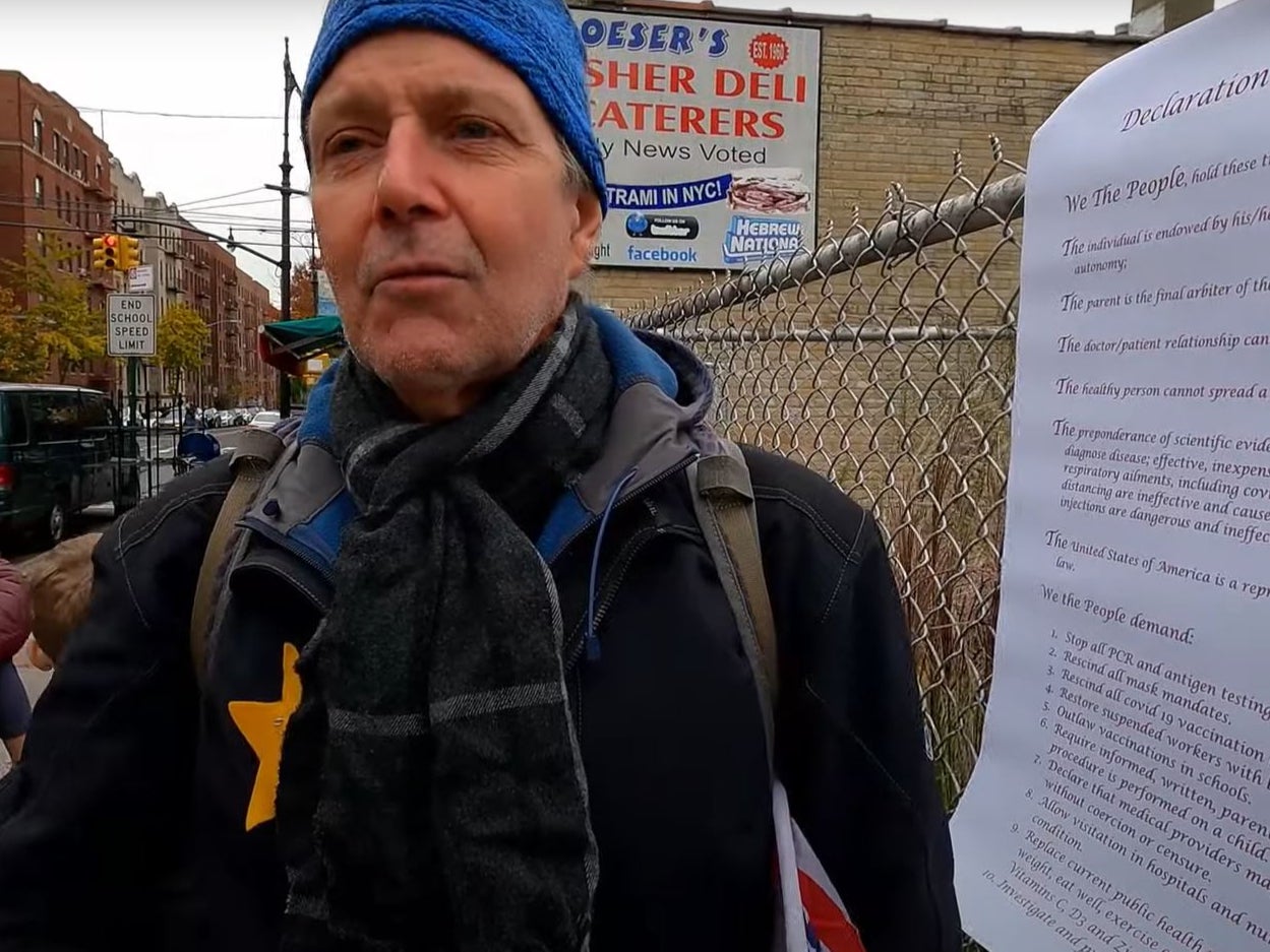 An anti-vaccine protester is seen wearing a yellow star on his chest in New York on Sunday