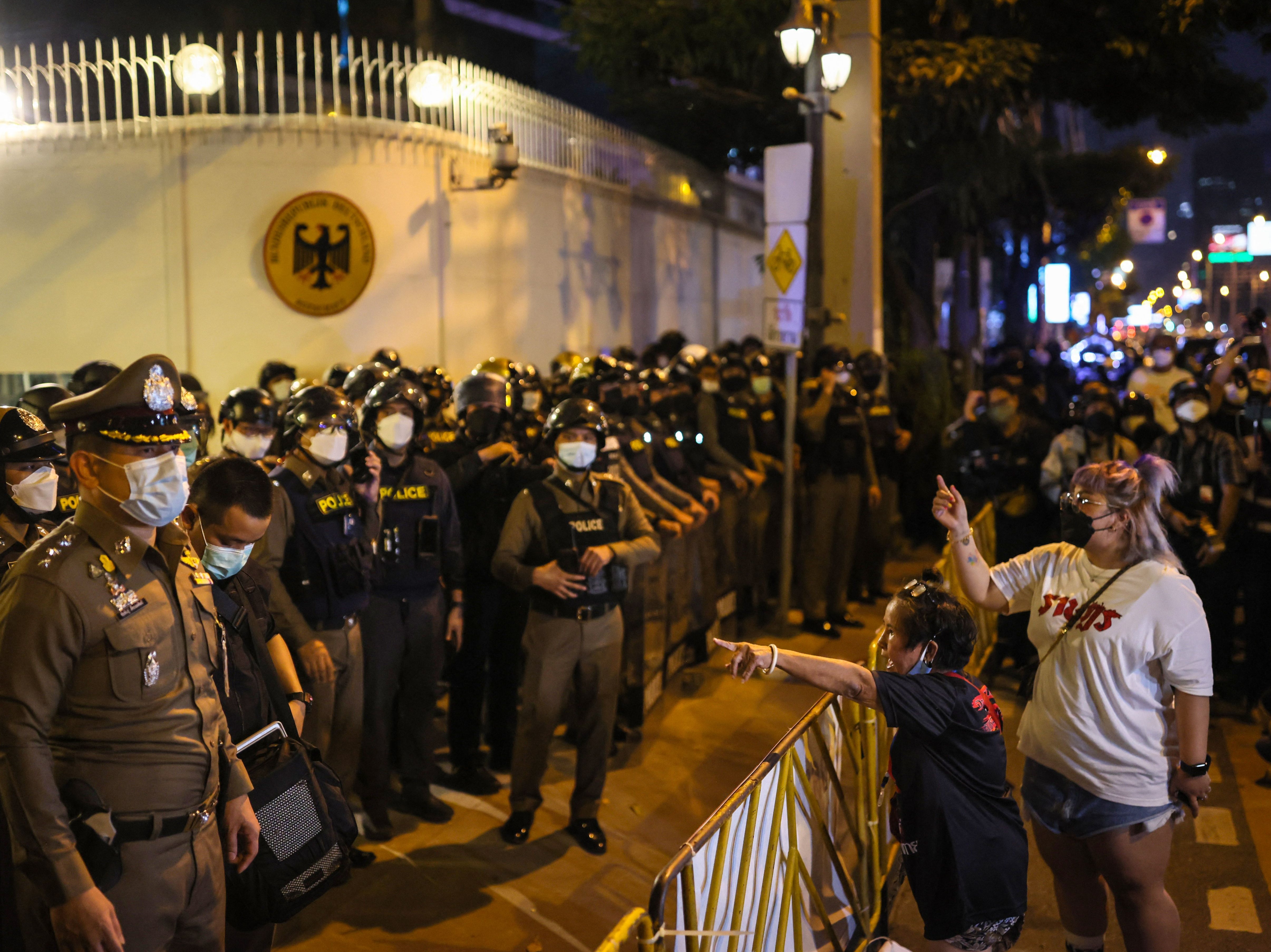 Protesters talk to the police in front of the German embassy during a demonstration in Bangkok on 14 November 2021