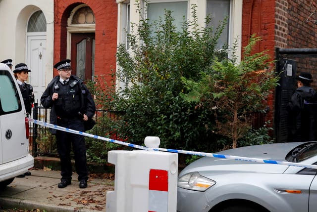 <p>Police officers keep guard outside a house in Kensington, where counter-terrorism officers arrested men on Sunday</p>