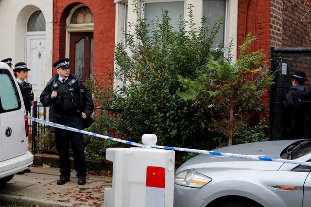 <p>Police officers keep guard outside a house in Kensington, where counter-terrorism officers arrested men on Sunday</p>