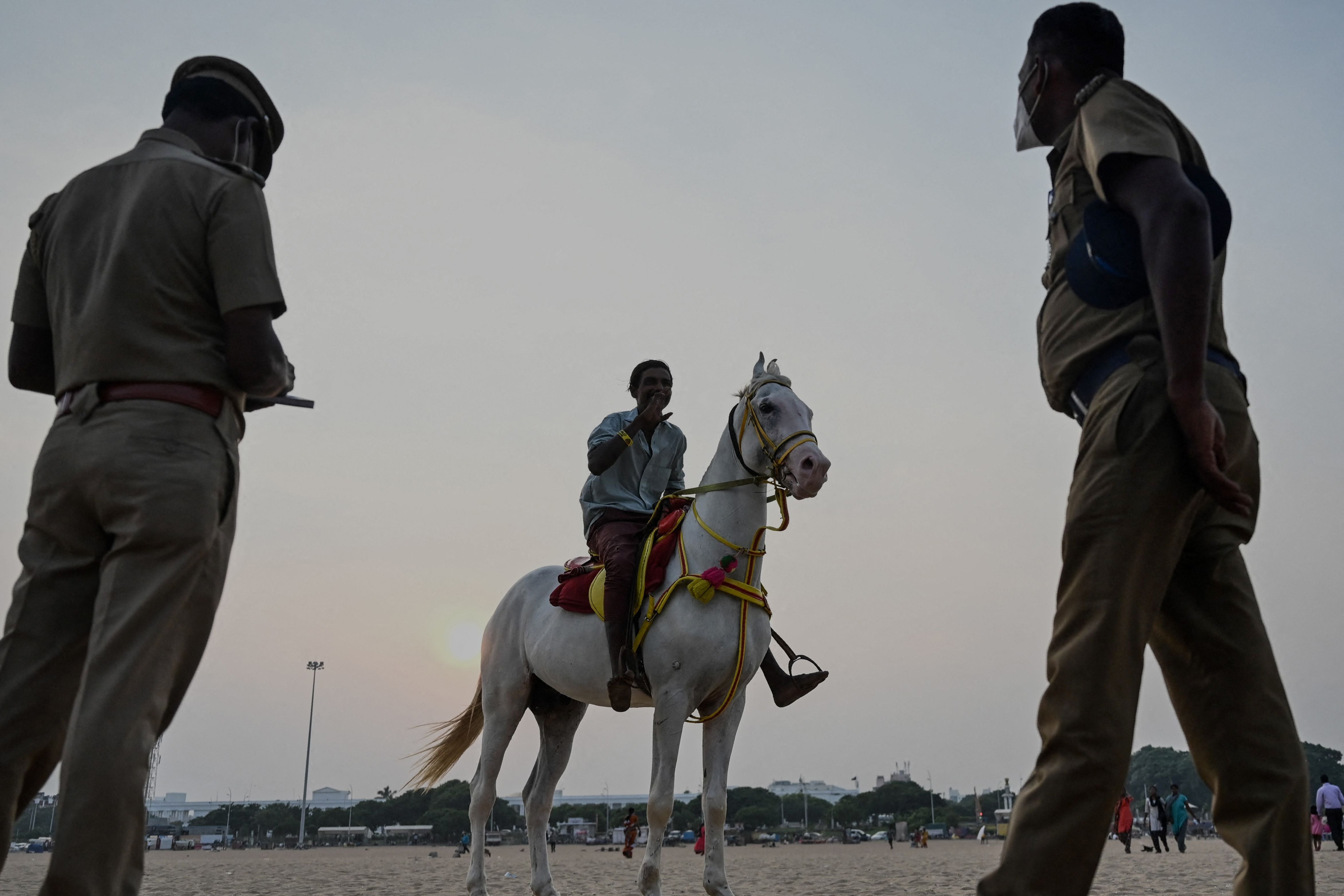 Police personnel stand at Marina beach in Chennai, Tamil Nadu