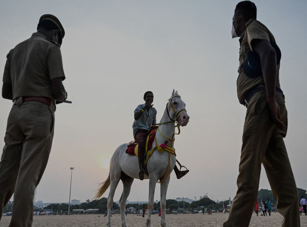<p>Police personnel stand at Marina beach in Chennai, Tamil Nadu</p>