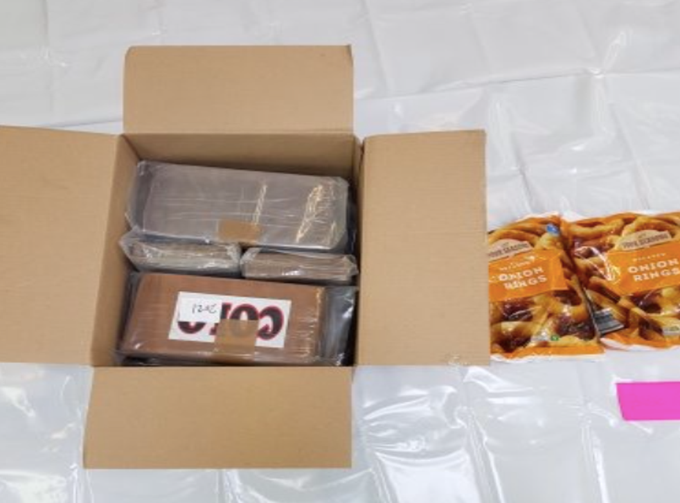 <p>Seize & onion: a picture provided by the National Crime Agency shows some of the confiscated cocaine and the onion rings it was shipped with </p>