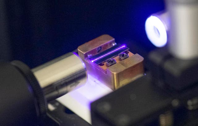 <p>A laser tests the optical waveguide of a chip for quantum computing in a laboratory at the technology company Q.ant in Stuttgart</p>