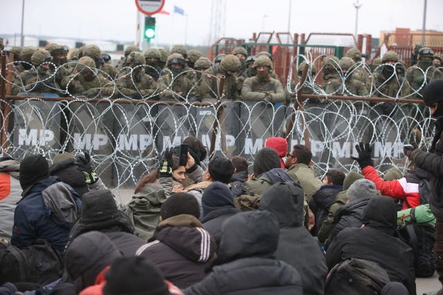 <p>Migrants gather on the Belarusian-Polish border in an attempt to cross it on Monday</p>