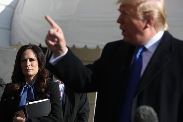 <p>White House Press Secretary Stephanie Grisham (L) listens to U.S. President Donald Trump talk to reporters before he boards Marine One and departing the White House November 08, 2019 in Washington, DC. </p>