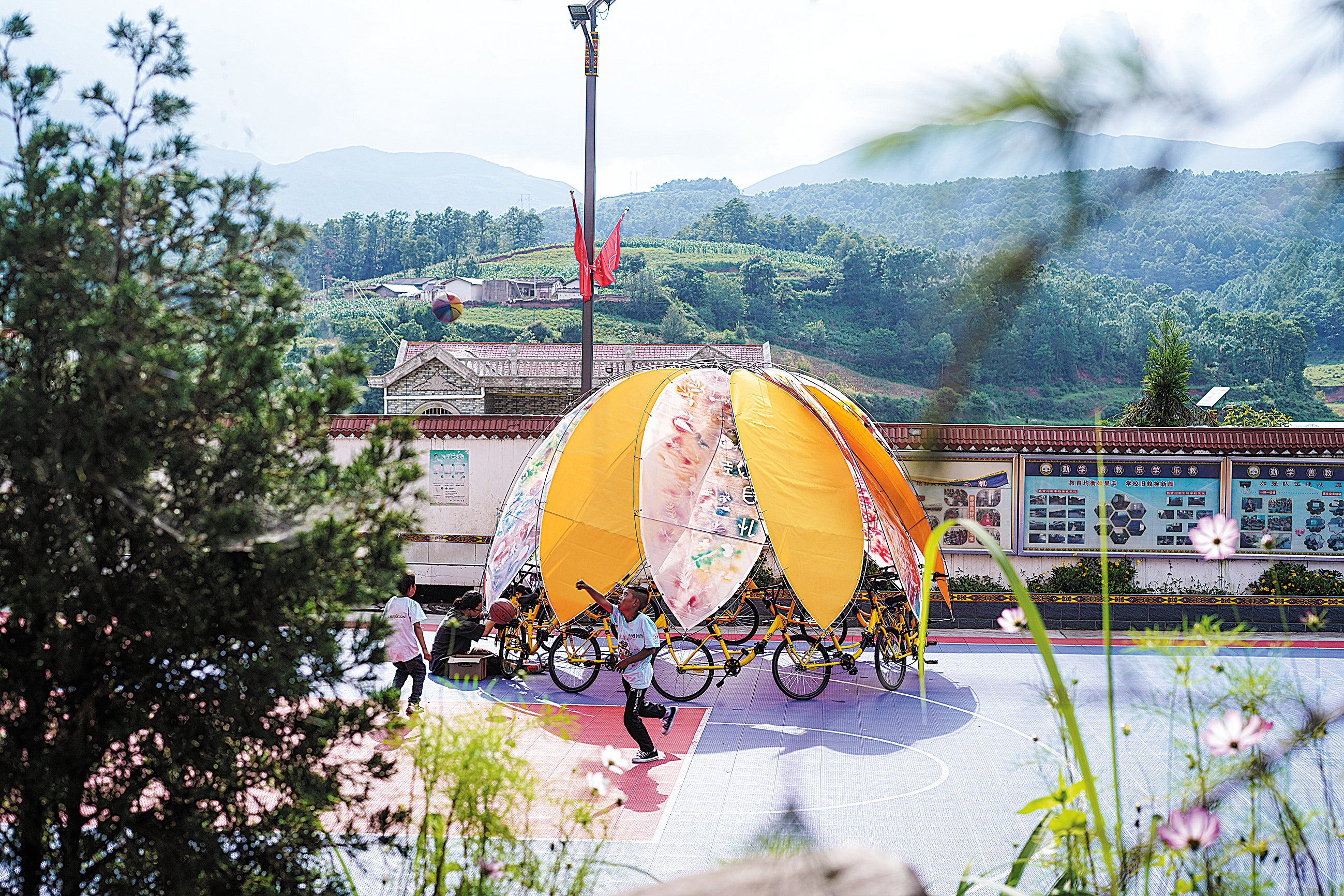 Children create a carousel-like installation in Puge county, Liangshan Yi autonomous prefecture, Sichuan province