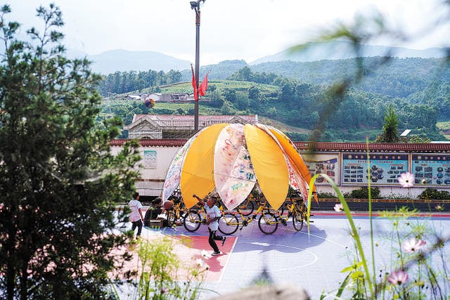 <p>Children create a carousel-like installation in Puge county, Liangshan Yi autonomous prefecture, Sichuan province</p>
