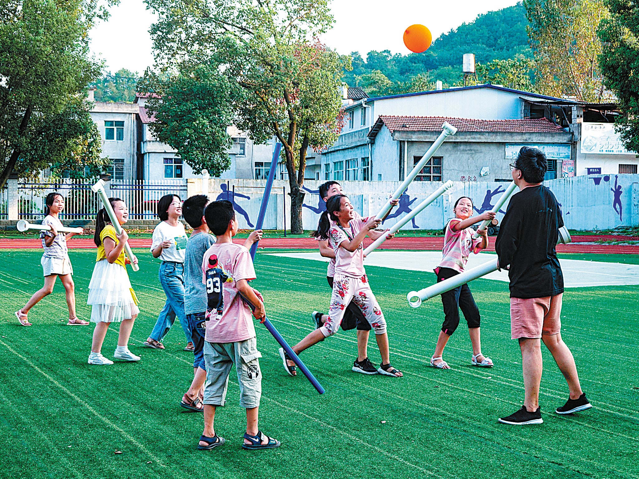 Children enjoy a Quidditch game with plastic drain pipes in the Dabie Mountain area in Hubei province