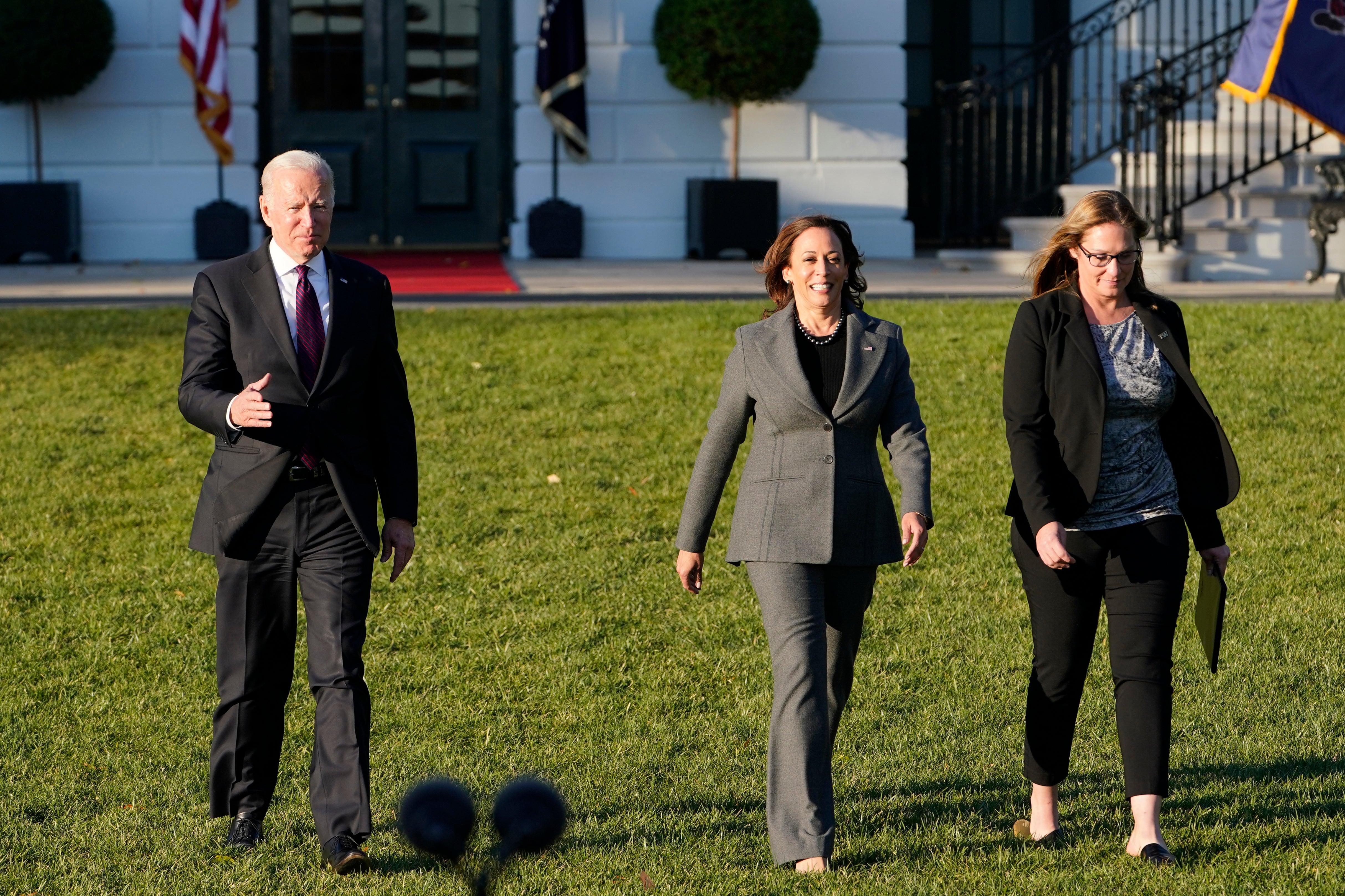 President Joe Biden, with Vice President Kamala Harris and Heather Kurtenbach, with Iron Workers Local 86 in Seattle, arrives to speak before signing the $1.2 trillion bipartisan infrastructure bill into law during a ceremony on the South Lawn of the White House in Washington, Monday, Nov. 15, 2021. (AP Photo/Susan Walsh)