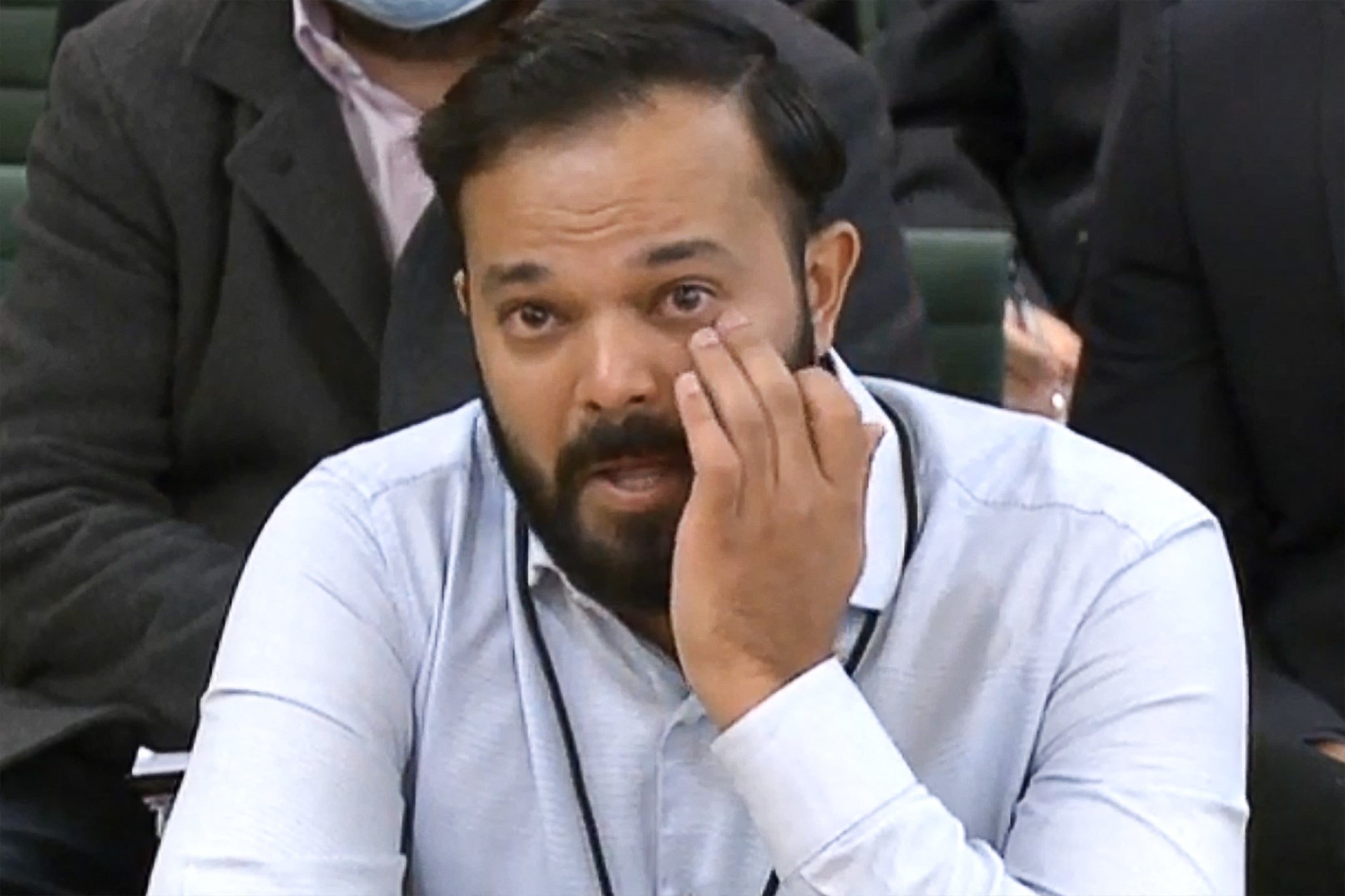 Former Yorkshire cricketer Azeem Rafiq fights back tears while testifying in front of a Digital, Culture, Media and Sport committee in London on Tuesday