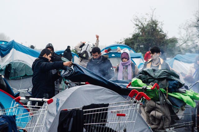 <p>Migrants, including some families with young children, could be seen packing their few belongings early on Tuesday morning</p>