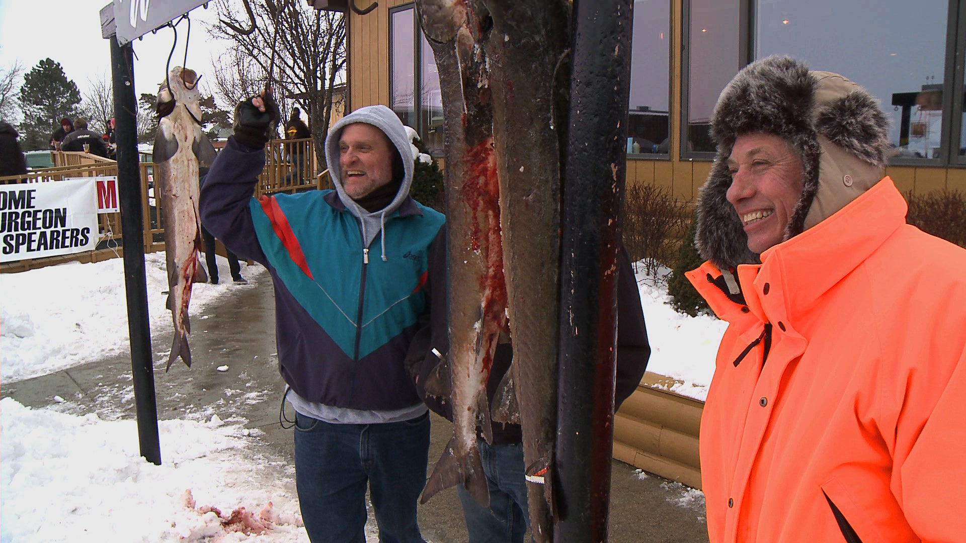 Sturgeon-spearers celebrate victory on the ice outside the local pub