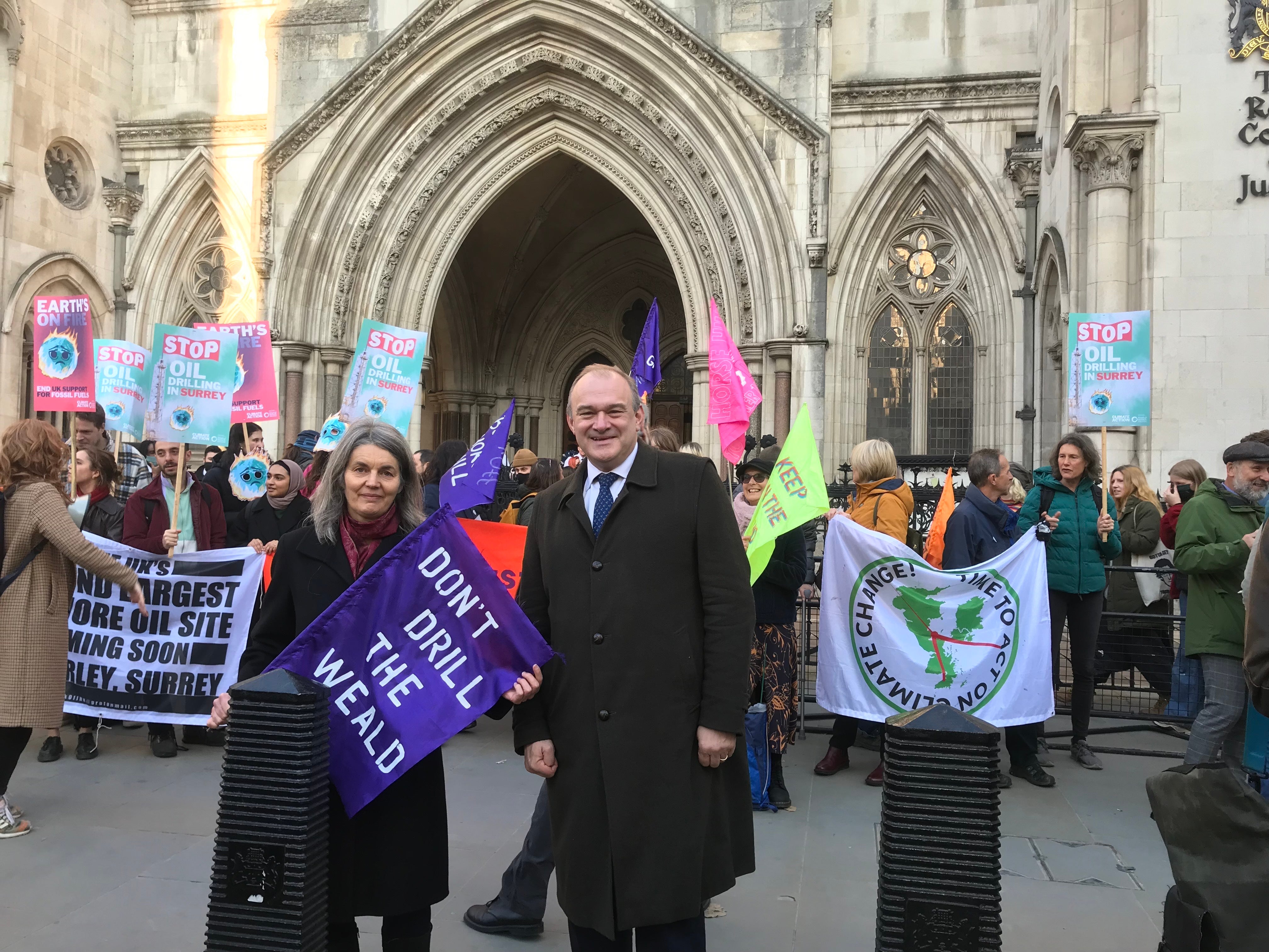 Sarah Finch and Ed Davey stand outside the Royal Courts of Justice before the Horse Hill hearing.