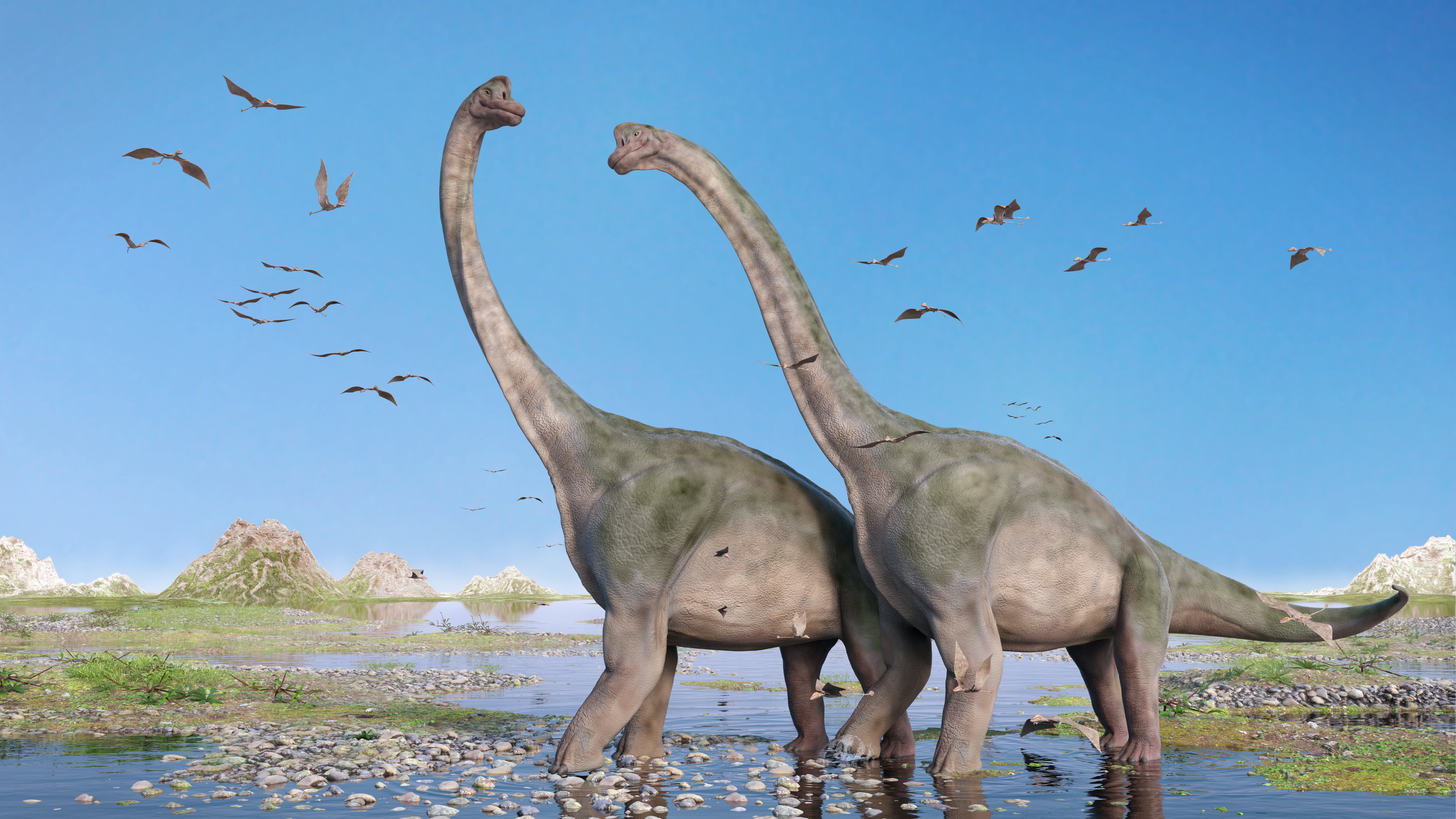 Giant sauropods walk through water amid a swarm of flying pterosaurs