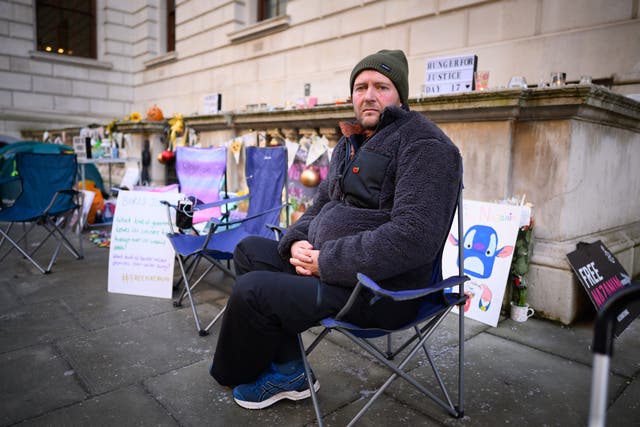 <p>Richard Ratcliffe sits in his temporary camp on day 17 of his hunger strike in front of the UK Foreign Office</p>