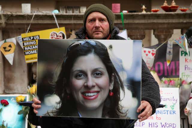 <p>Richard Ratcliffe clutches wife’s picture on 19th day of hunger strike outside  Foreign Office in November </p>