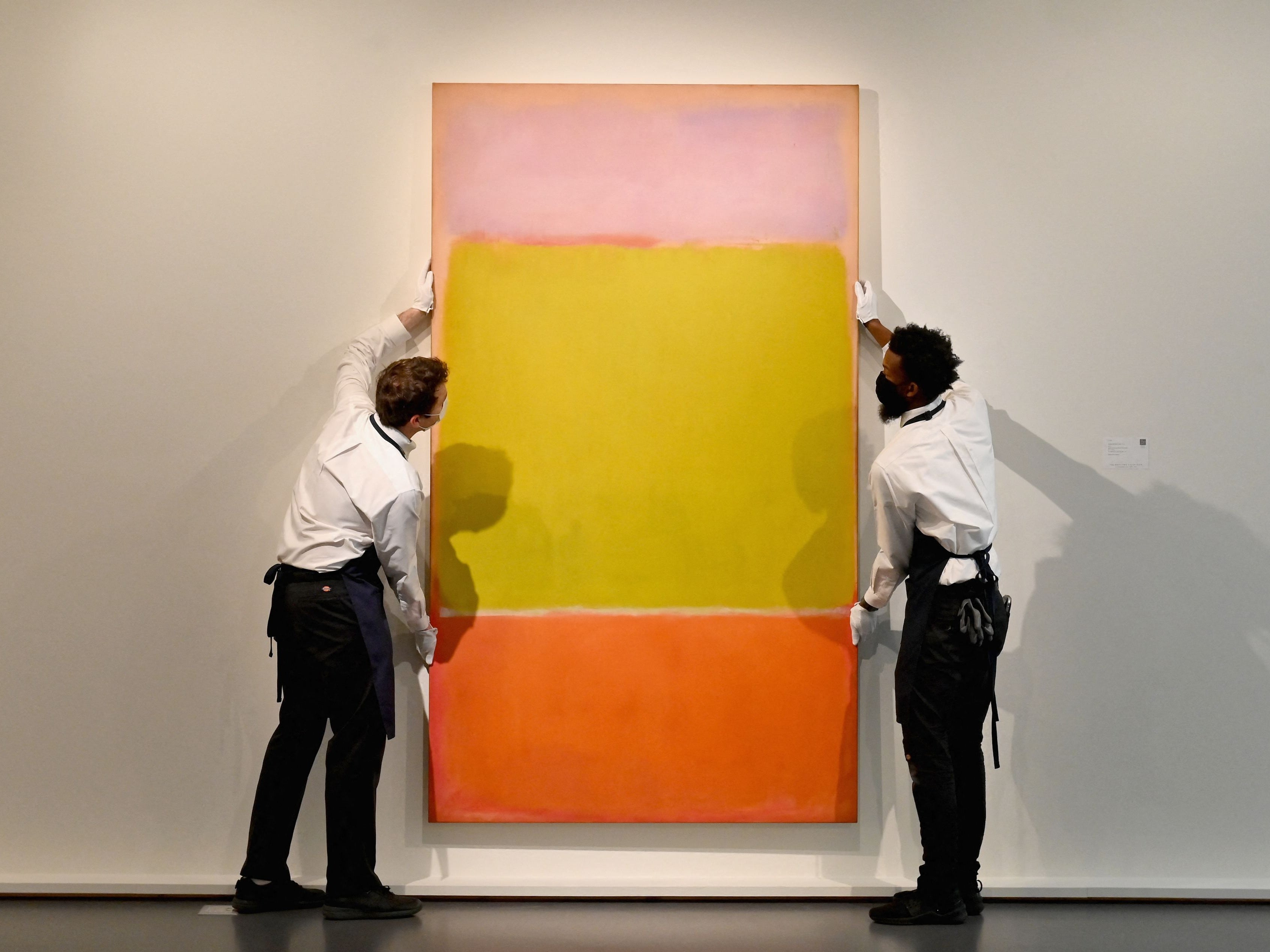 Art handlers hang Mark Rothko’s ‘No. 7’, part of The Macklowe Collection, at Sotheby’s on 5 November, 2021 in New York City