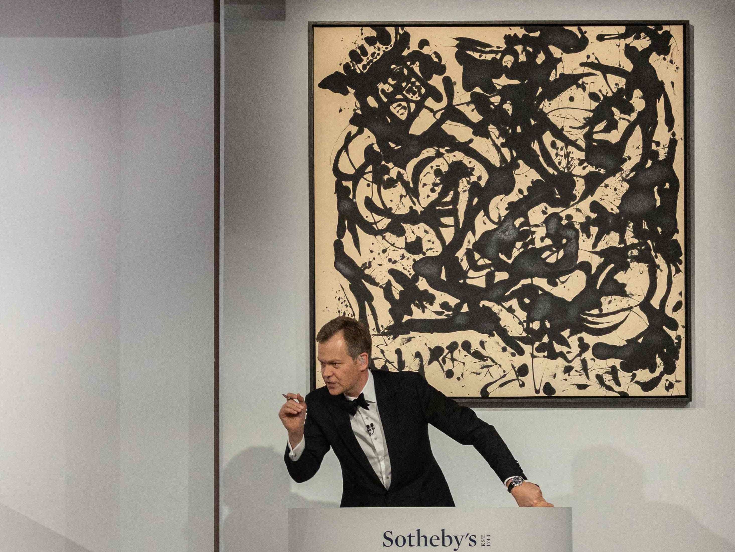 Sotheby’s auctioneer Oliver Barker leads an auction of the Macklowe Collection alongside Robert Ryman’s ‘Untitled’ in New York, 15 November, 2021