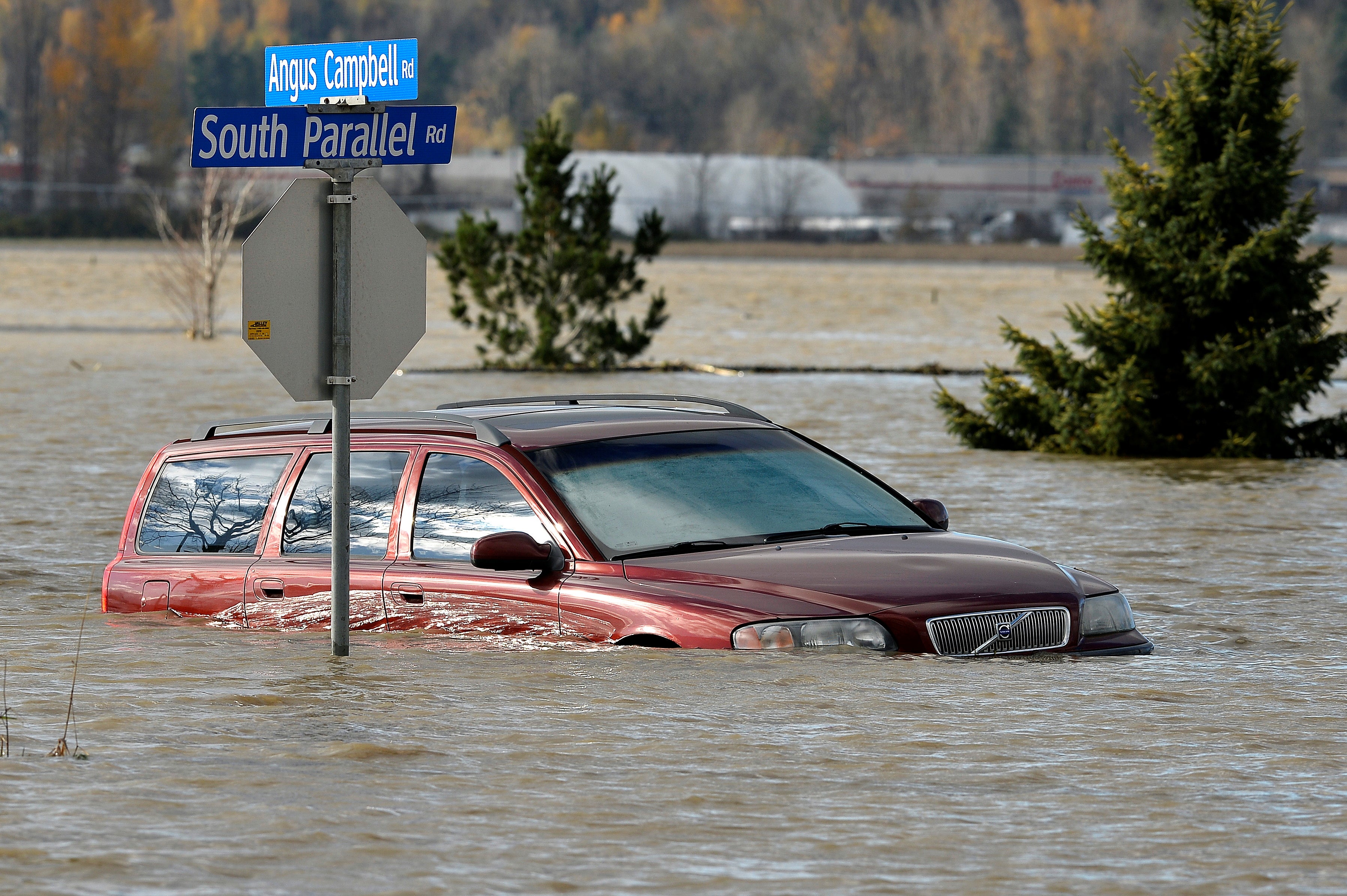 A vehicle is submerged in water after rainstorms caused flooding and landslides in Abbotsford, British Columbia