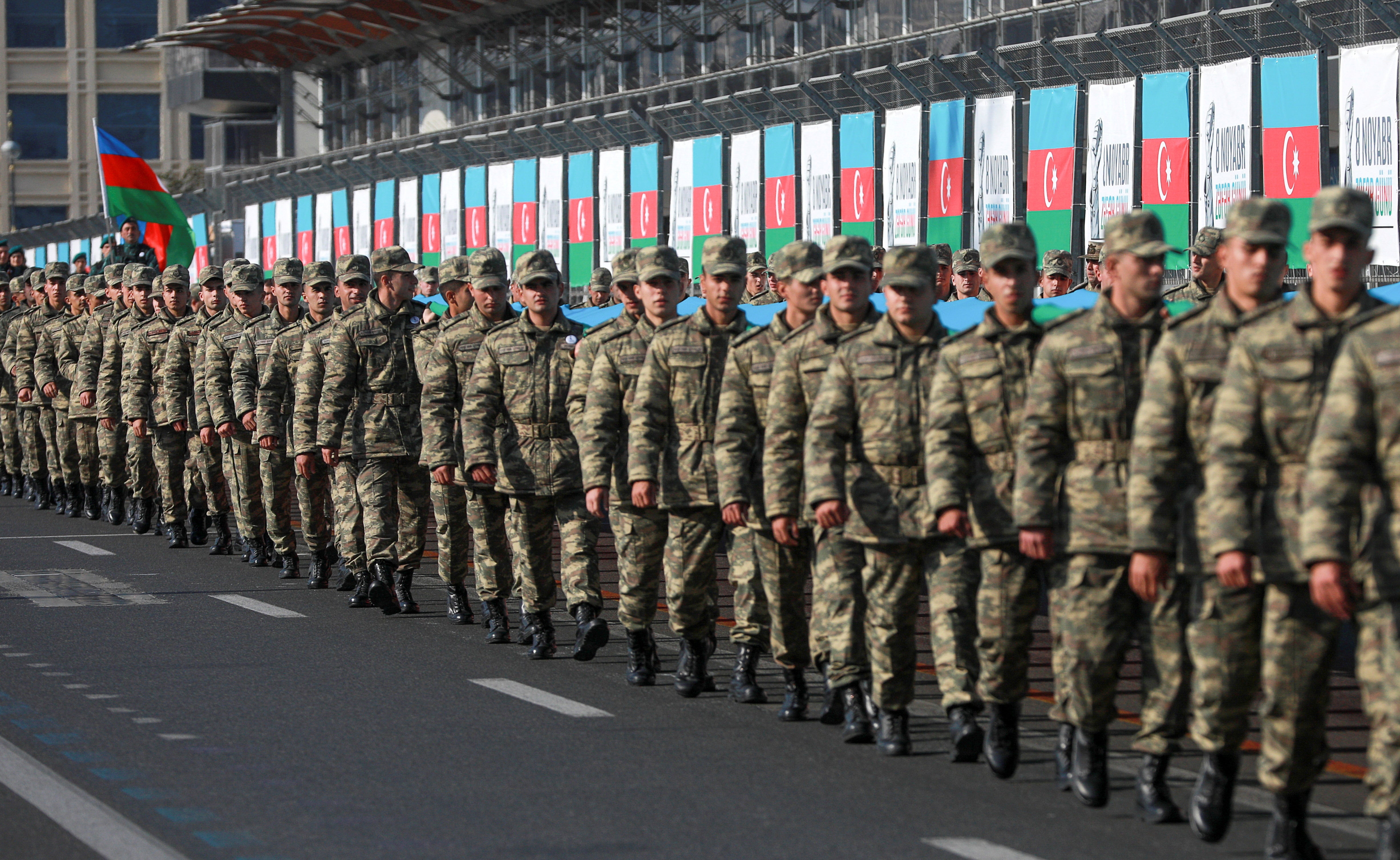 <p>Azeri service members mark the anniversary of the end of the 2020 military conflict over Nagorno-Karabakh</p>
