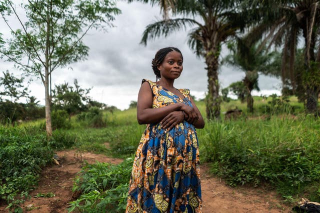 <p>Kisimba on her farm in Tundwa five years after her family was uprooted by a militia attack on their home</p>