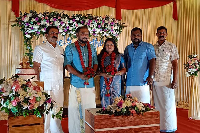 <p>From left: Marx joins the groom, Engels, the bride, Bismitha, Lenin and Ho Chi Minh for a group photo during the wedding in Athirappilly, Kerala</p>
